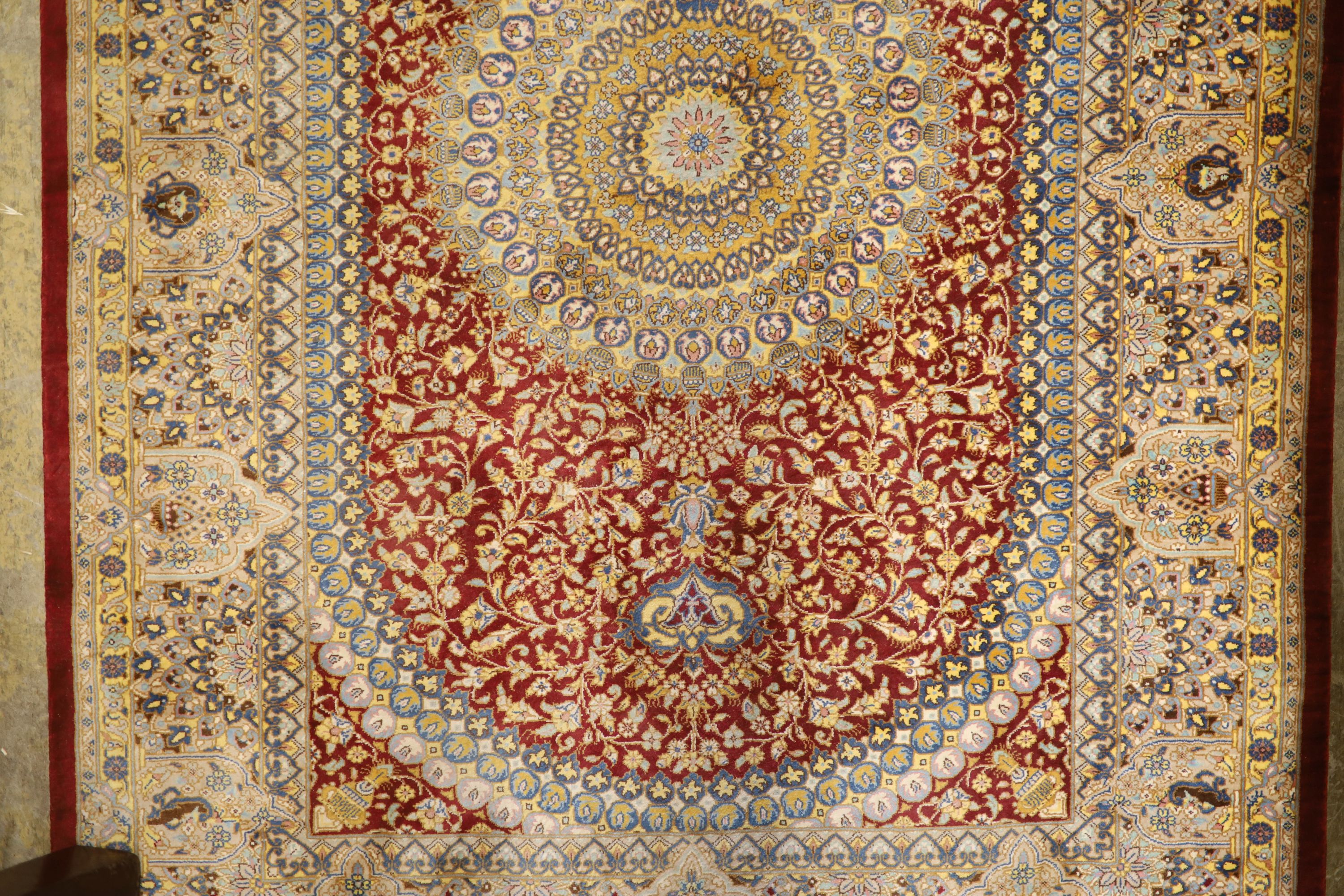 A Persian part red ground silk multi-floral patterned rug, 110 x 80cm